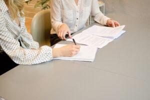 office women signing documents