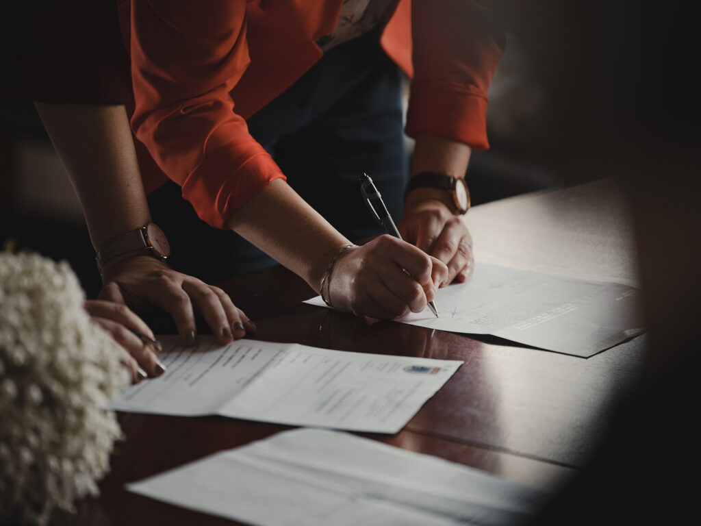 Woman signing Non-compete agreement