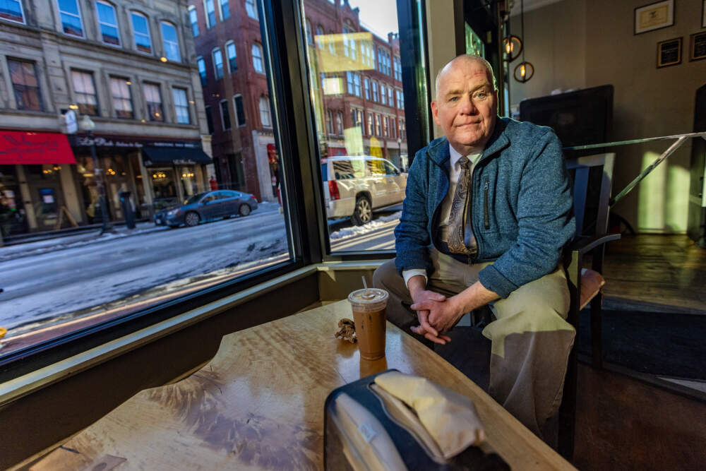 Robert Hanson enjoys an iced beverage inside Battle Grounds Coffee Company in downtown Haverhill. (Jesse Costa/WBUR)